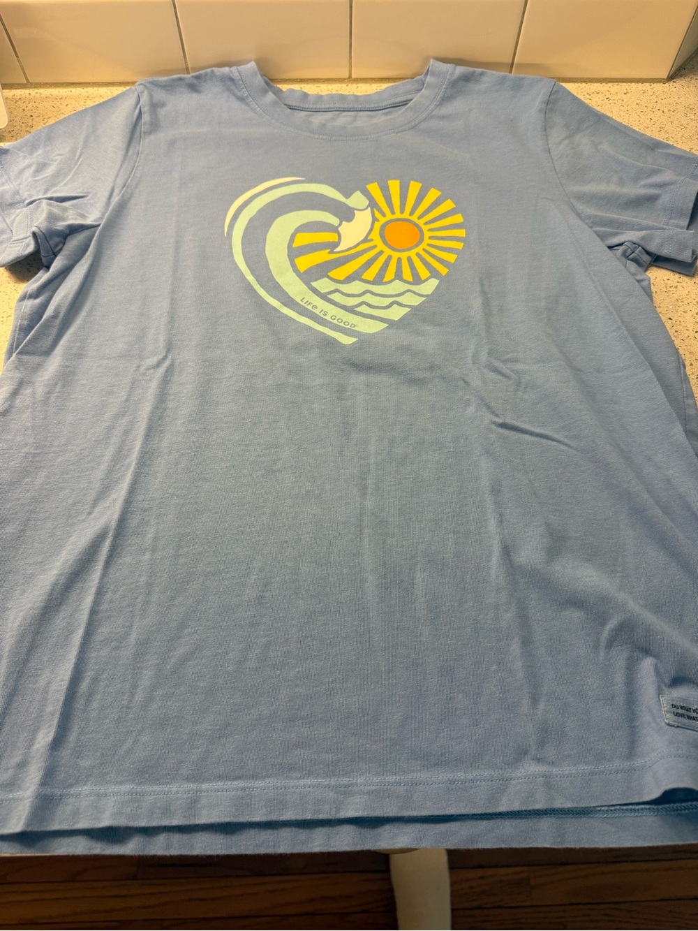 Life Is Good Light Woman’s Blue Tee with Yellow Sun & Pale Green Wave Heart